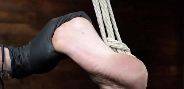  Brunette in rope bondage gets whipped